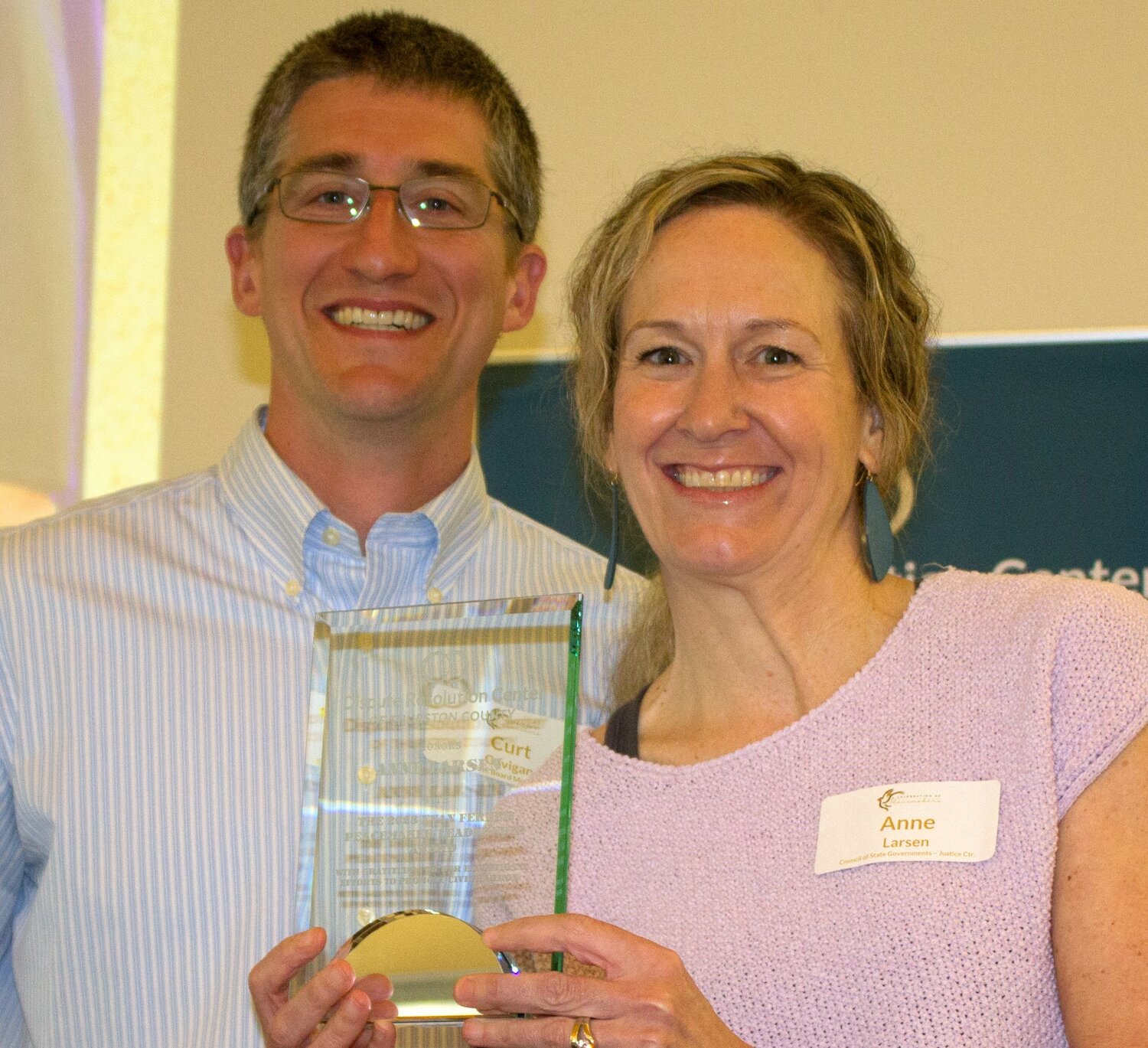 Anne Larsen received the Peacemaker Award from DRC Board Vice President Curt Gavigan at DRC Peacemaker Celebration event on May 7, 2023.